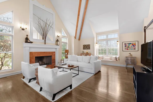 a living room with furniture a fireplace and a flat screen tv