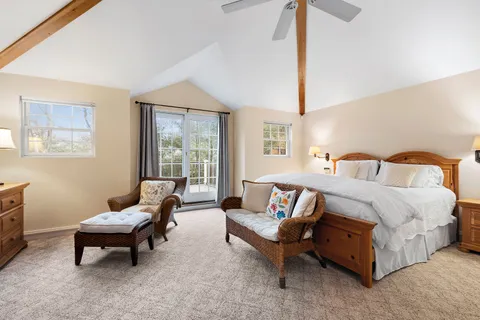 a spacious bedroom with a bed and a couch