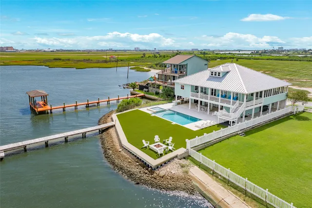 a view of a swimming pool with lawn chairs