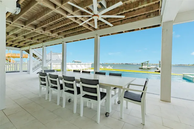 a view of a swimming pool with an outdoor seating and a yard