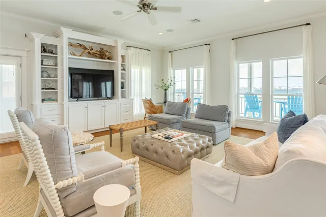 a view of a dining room and livingroom with furniture wooden floor a chandelier