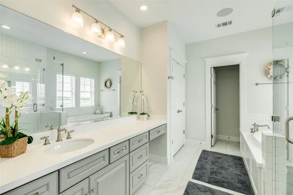 a bathroom with a tub shower and sink