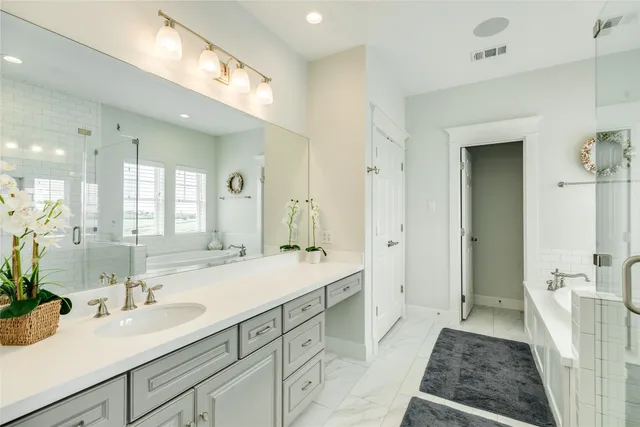 a bathroom with a tub shower and sink