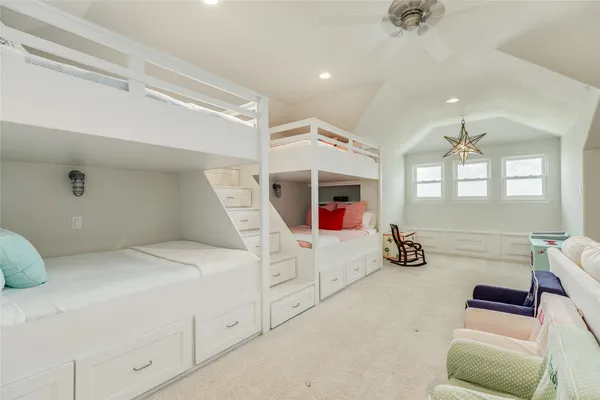 a bathroom with a double vanity sink and mirror with toilet