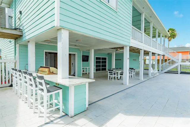 a view of a porch with furniture and wooden floor