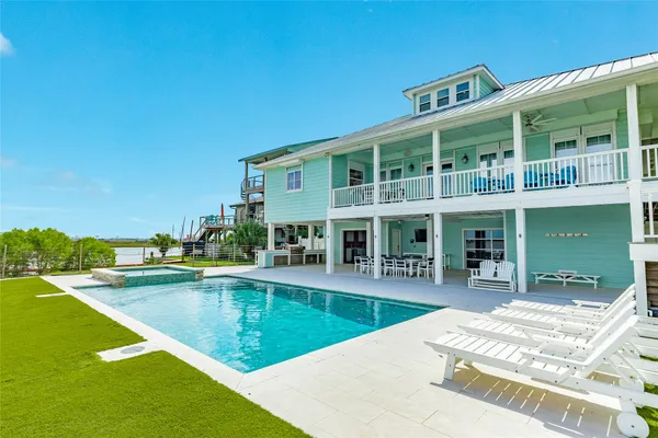 a view of a swimming pool with outdoor seating