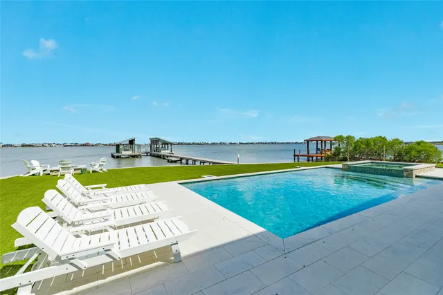 a view of a swimming pool and lounge chair