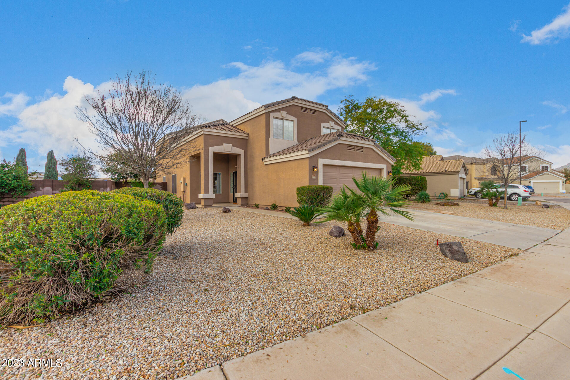2561 West Tanner Ranch Road Queen Creek, AZ 85144 - Photo 1 of 36 a front view of a house with a garden