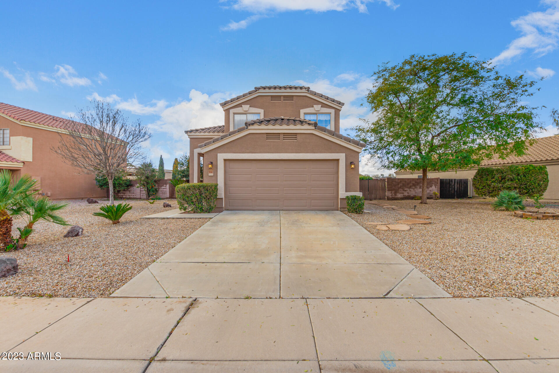 2561 West Tanner Ranch Road Queen Creek, AZ 85144 - Photo 2 of 36 a front view of a house with a yard and trees