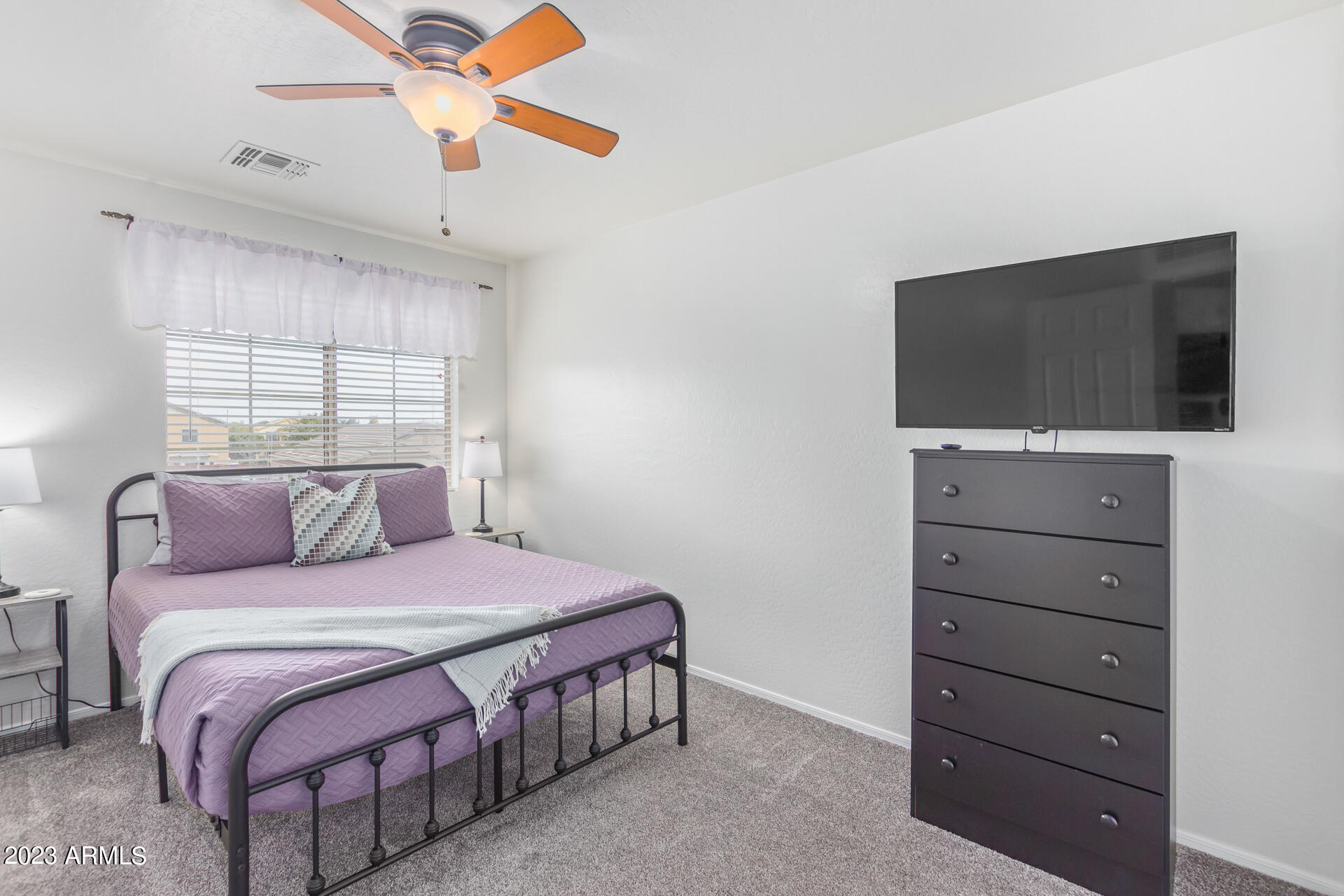 2561 West Tanner Ranch Road Queen Creek, AZ 85144 - Photo 25 of 36 a bedroom with a bed and a flat screen tv