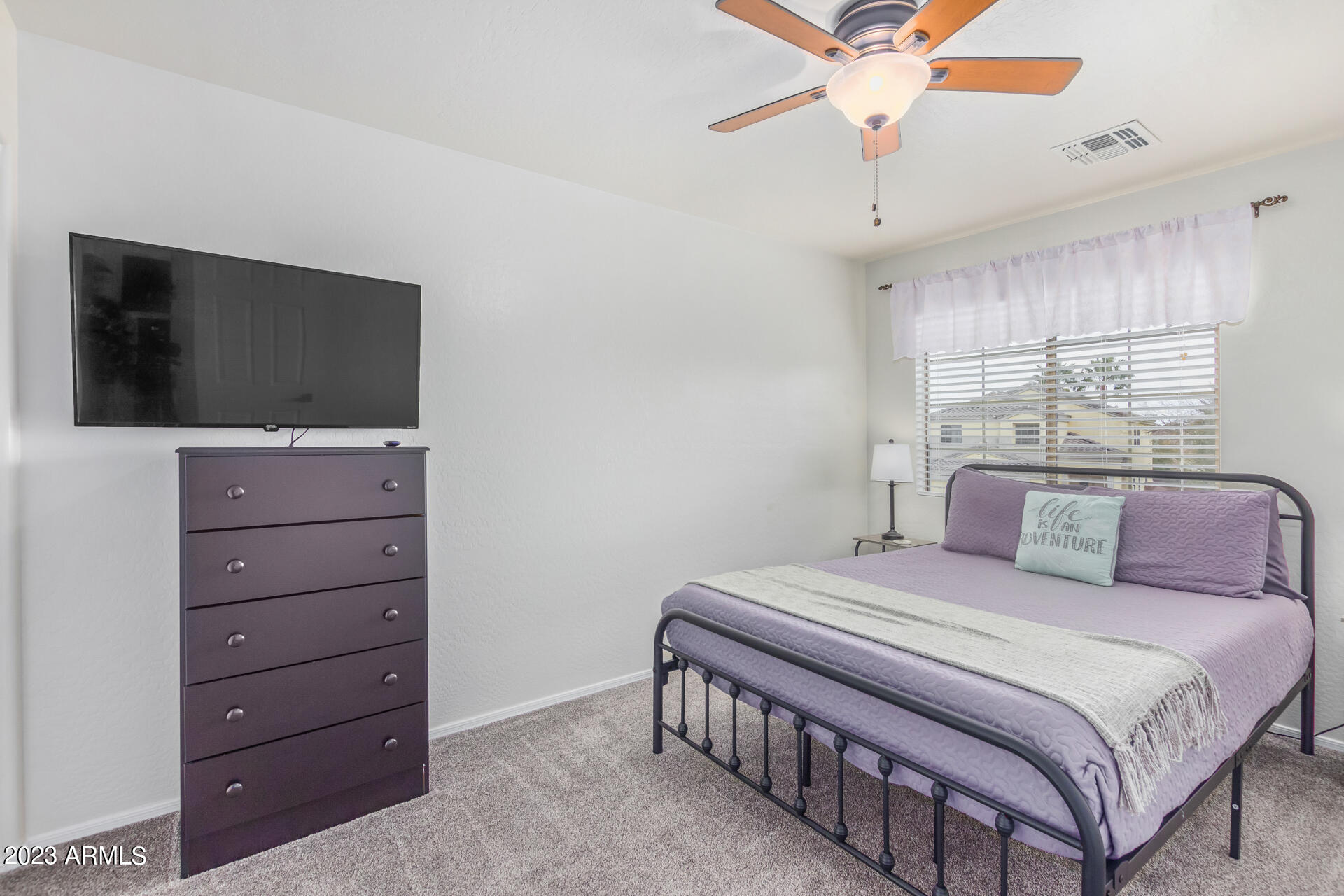 2561 West Tanner Ranch Road Queen Creek, AZ 85144 - Photo 27 of 36 a bedroom with a bed and a flat screen tv
