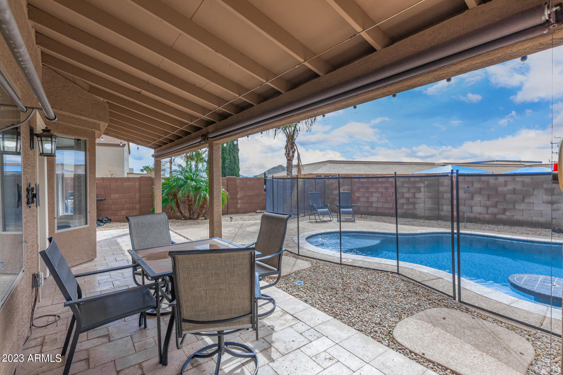 2561 West Tanner Ranch Road Queen Creek, AZ 85144 - Photo 31 of 36 a view of a patio with a table chairs and a table