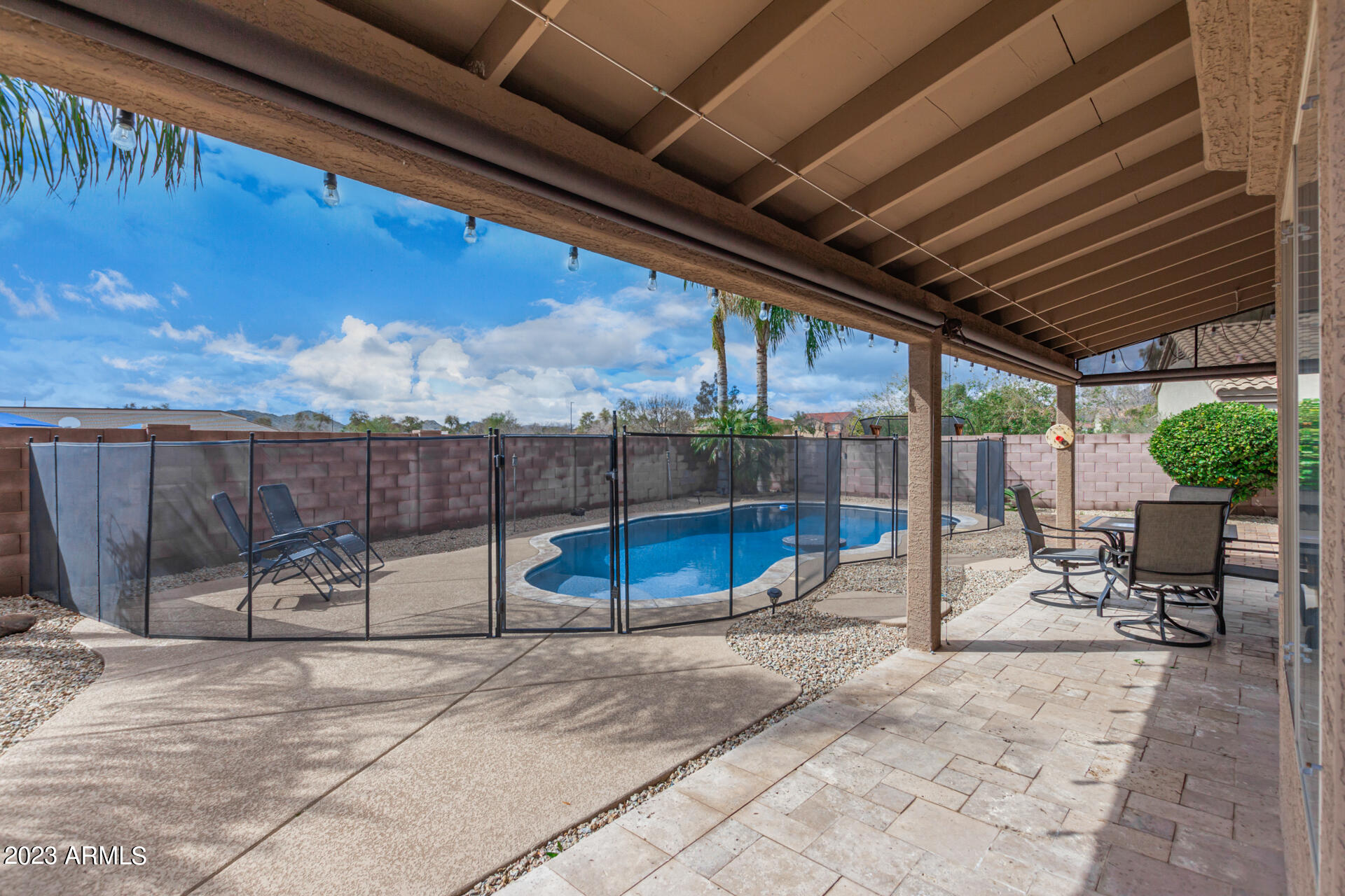 2561 West Tanner Ranch Road Queen Creek, AZ 85144 - Photo 32 of 36 a view of a patio with a table and chairs