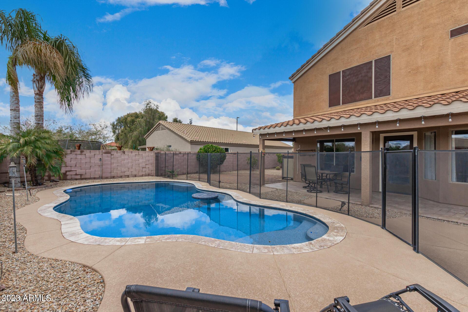 2561 West Tanner Ranch Road Queen Creek, AZ 85144 - Photo 36 of 36 a view of a swimming pool with a patio