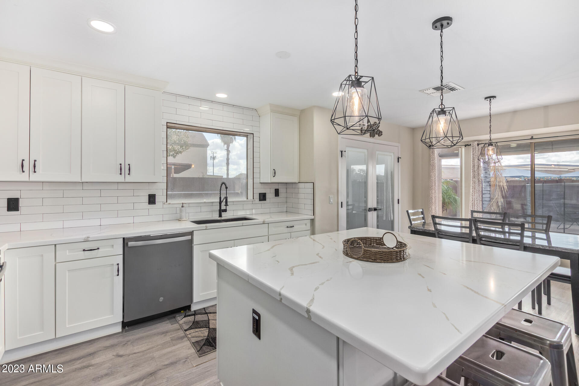 2561 West Tanner Ranch Road Queen Creek, AZ 85144 - Photo 7 of 36 a kitchen with a sink a center island and cabinets