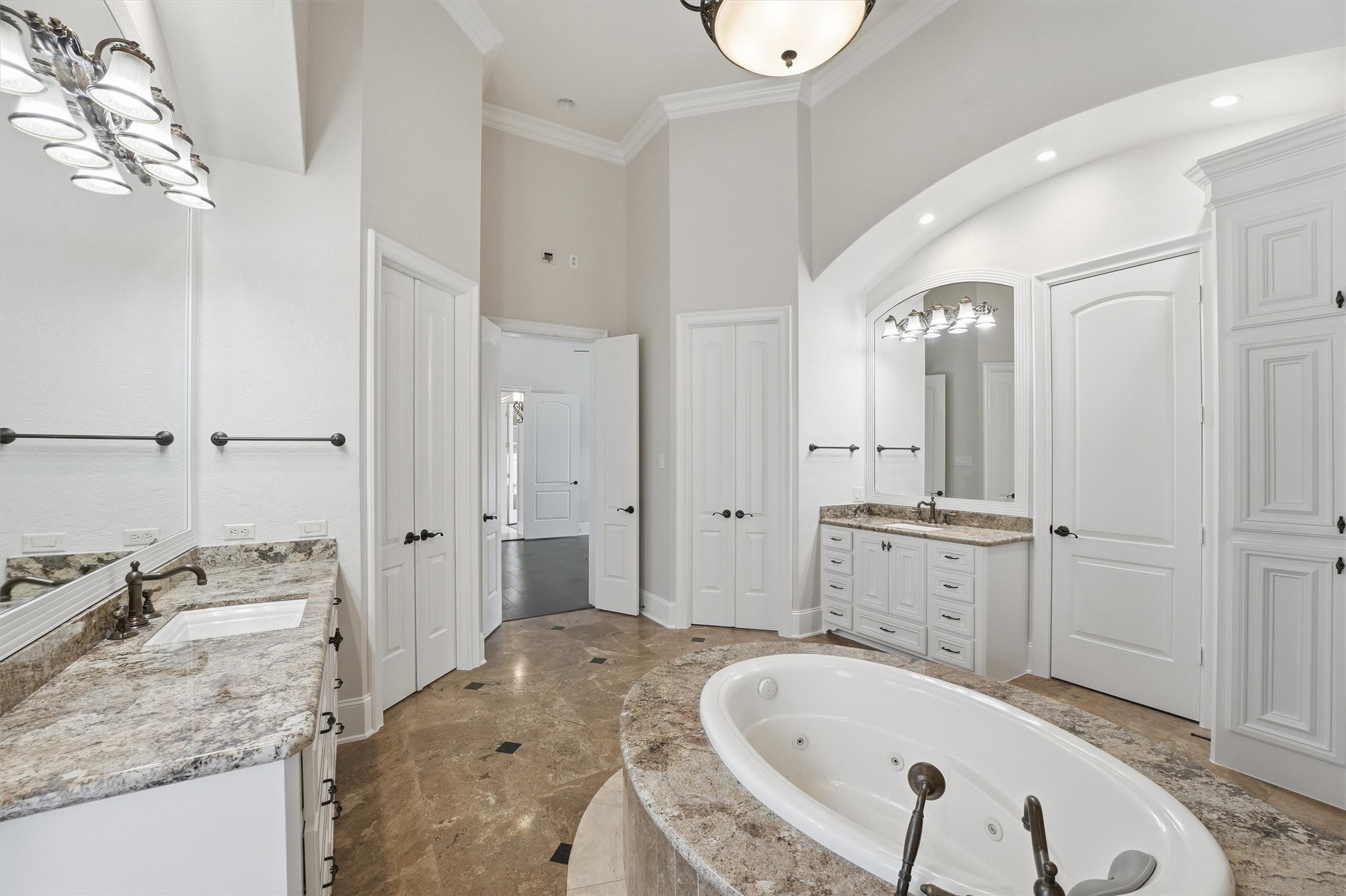 70 Quail Rock Place The Woodlands, TX 77381 - Photo 19 of 46 a spacious bathroom with a granite countertop sink mirror and a bathtub