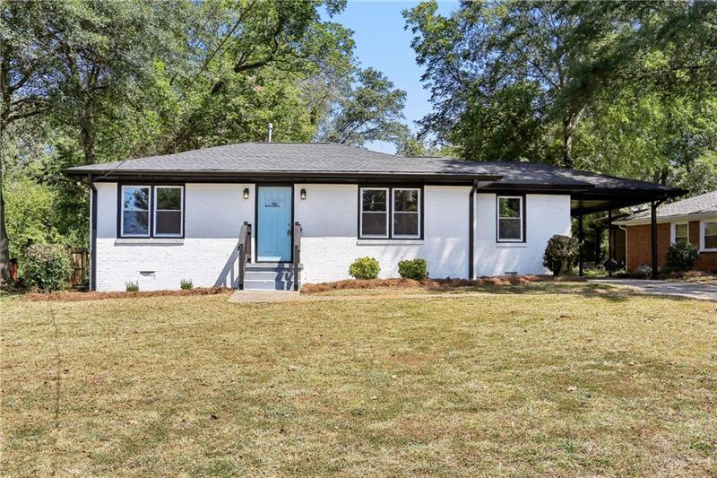 1709 Valencia Road Decatur, GA 30032 - Photo 1 of 1 a house that has a tree in front of it