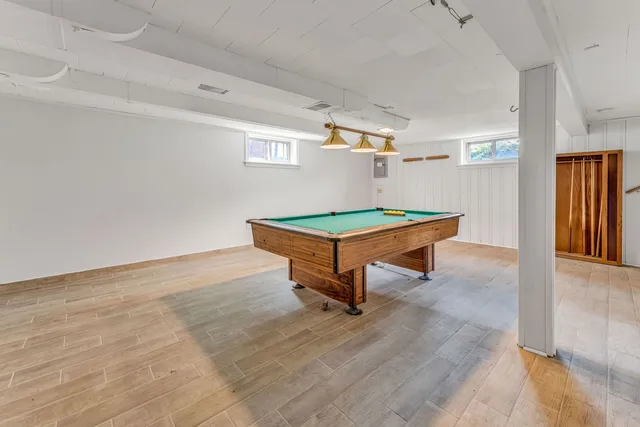 a room with pool table and window