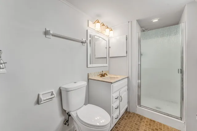 a bathroom with a toilet a sink and shower