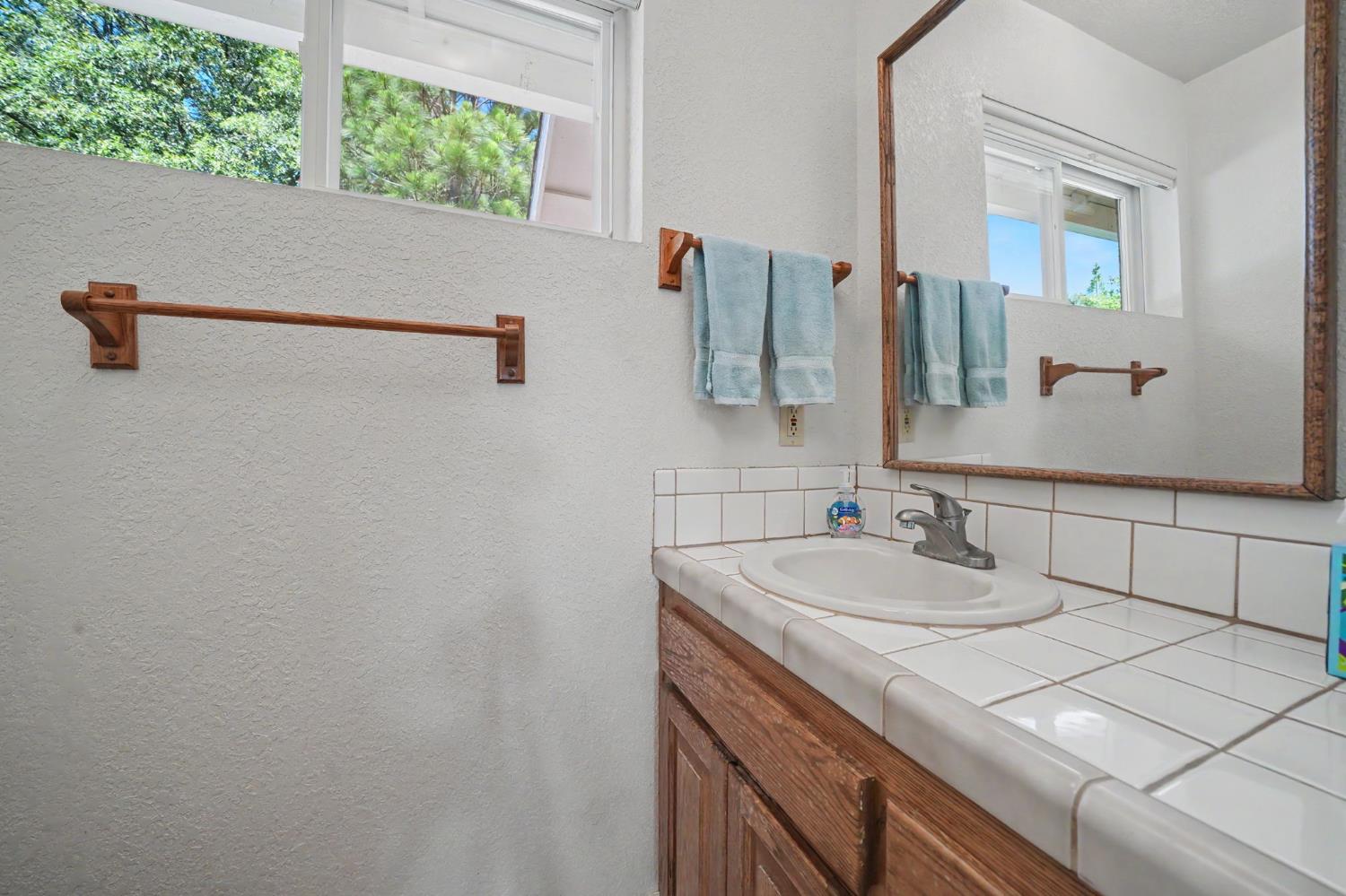 18299 West Clinton Road Jackson, CA 95642 - Photo 31 of 56 a bathroom with a sink and a mirror