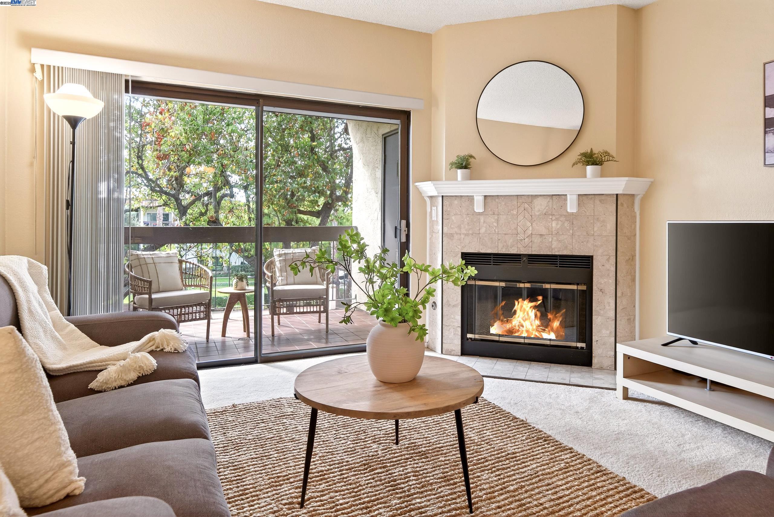 a living room with furniture a window and a fireplace