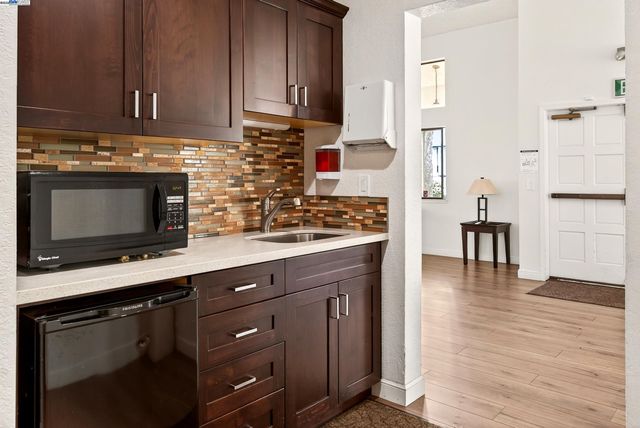 a kitchen with stainless steel appliances wooden cabinets and a stove top oven
