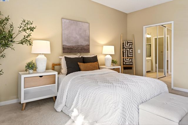 a bedroom with a bed and a night stand