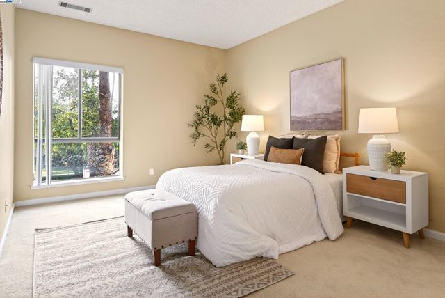 a bedroom with a bed and a window