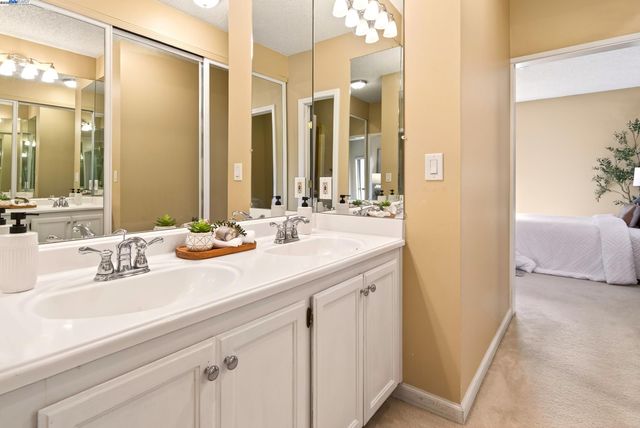 a en suite bathroom with double sink and a mirror