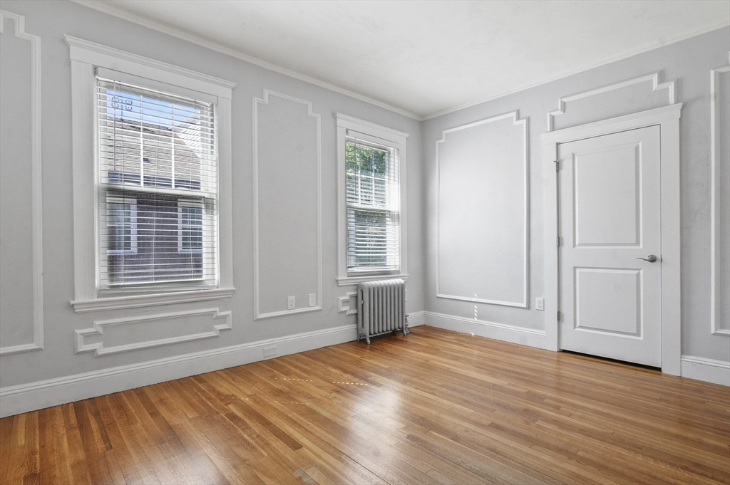 91 Verndale Street, Unit 2 Brookline, MA 02446 - Photo 12 of 18 a view of empty room with wooden floor and fan