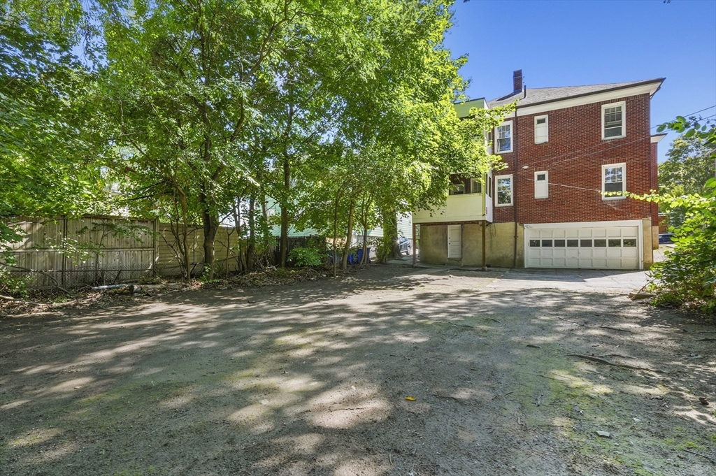 91 Verndale Street, Unit 2 Brookline, MA 02446 - Photo 17 of 18 a front view of a house with a yard