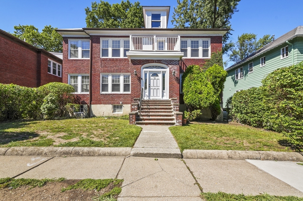 91 Verndale Street, Unit 2 Brookline, MA 02446 - Photo 18 of 18 a front view of a house with garden