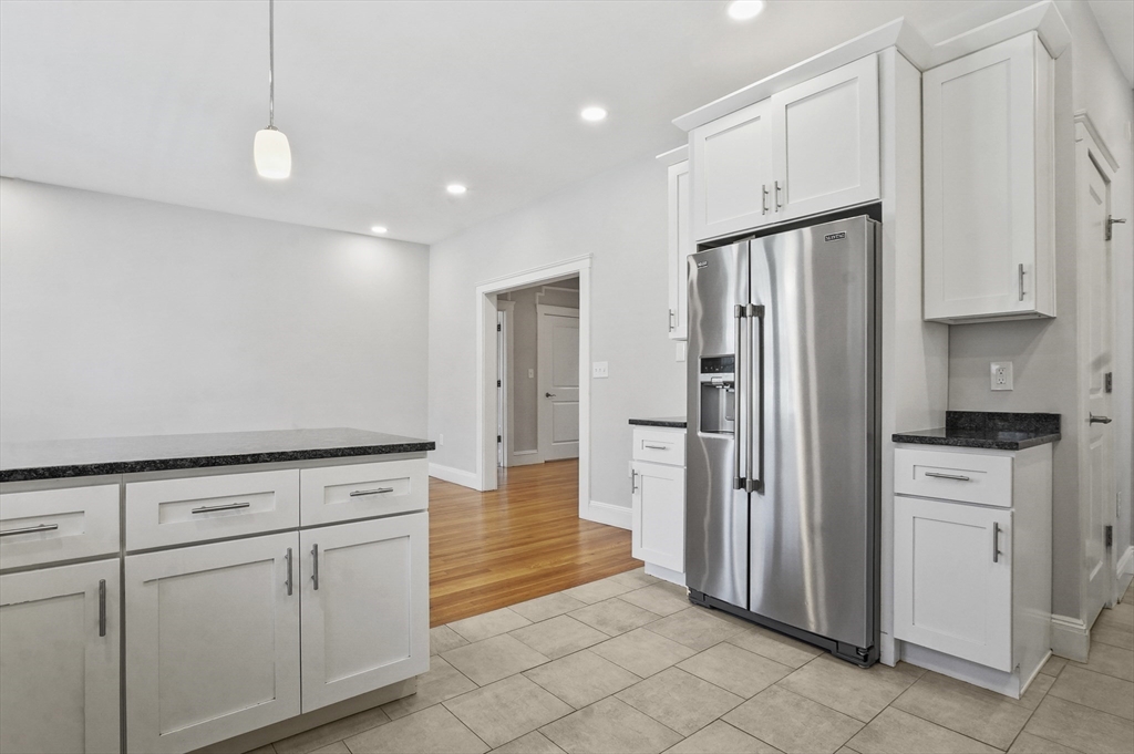 91 Verndale Street, Unit 2 Brookline, MA 02446 - Photo 3 of 18 a kitchen with white cabinets and refrigerator