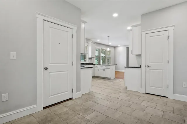 a view of a kitchen with white cabinets