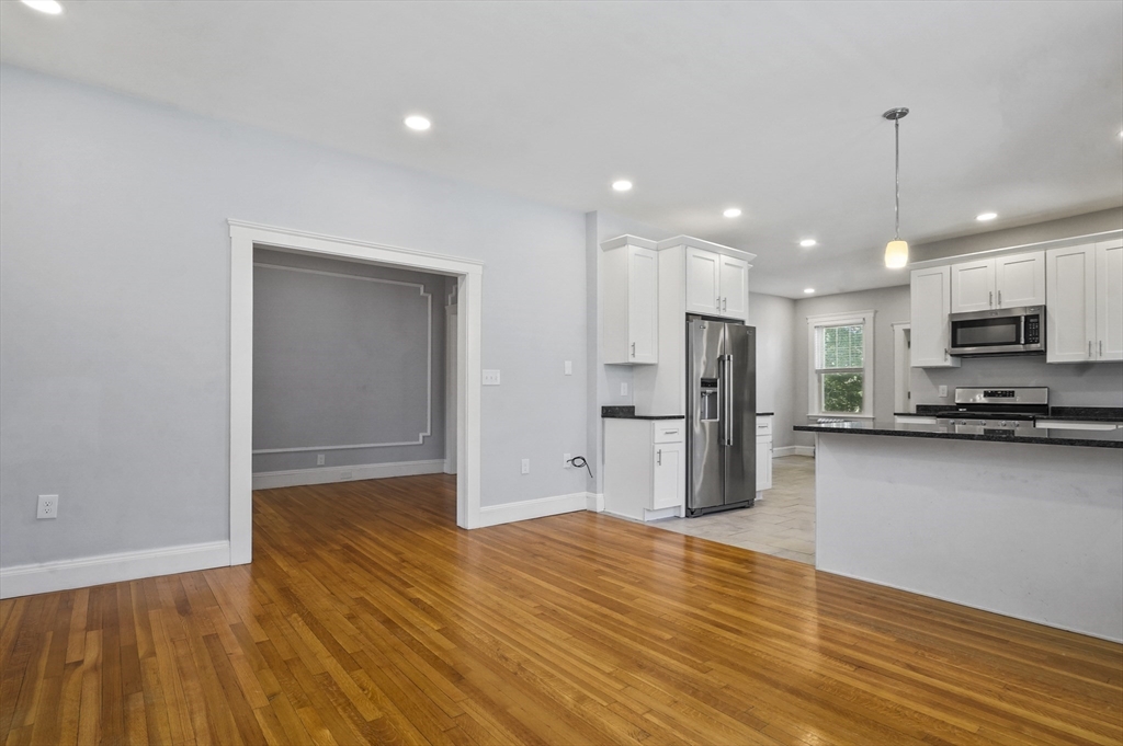 91 Verndale Street, Unit 2 Brookline, MA 02446 - Photo 5 of 18 a view of kitchen with stainless steel appliances granite countertop a refrigerator and a stove top oven