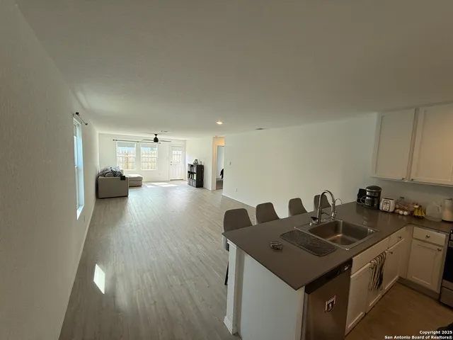 a kitchen with a sink a stove and cabinets