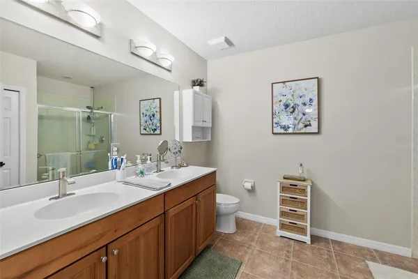 a bathroom with a double vanity sink and a mirror