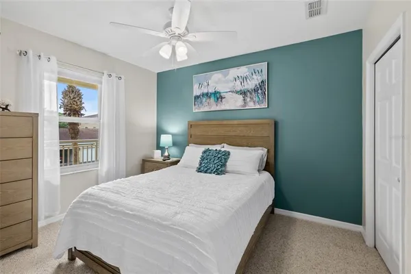a bedroom with a large bed and a chandelier