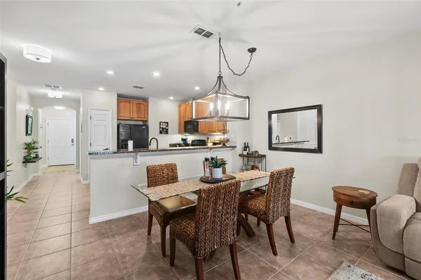 a view of a dining room and livingroom with furniture wooden floor a chandelier