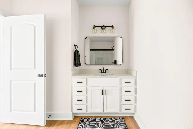 a bathroom with a sink vanity and mirror