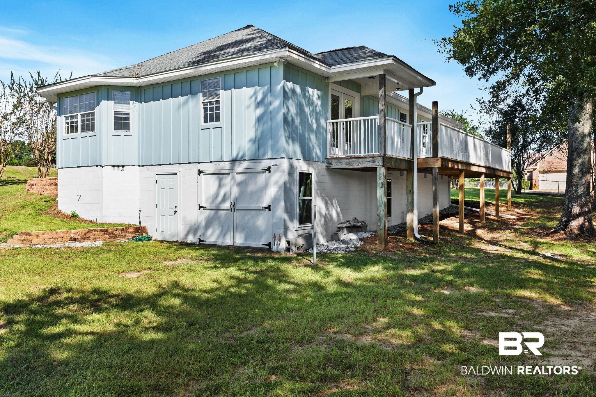 35650 Spring Road North Stapleton, AL 36578 - Photo 55 of 70 View of side of property featuring a yard, hardie siding, a wood deck, and roof with shingles