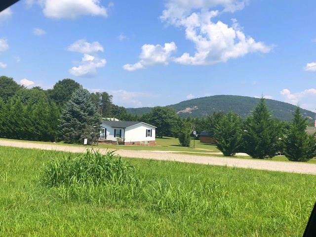 1317 Poole Gooden Road Hiddenite, NC 28636 - Photo 2 of 36 a view of a big yard with lots of green space and mountain view