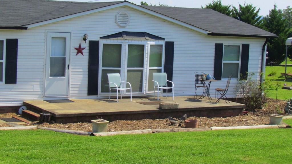 1317 Poole Gooden Road Hiddenite, NC 28636 - Photo 13 of 36 a front view of house with yard and patio