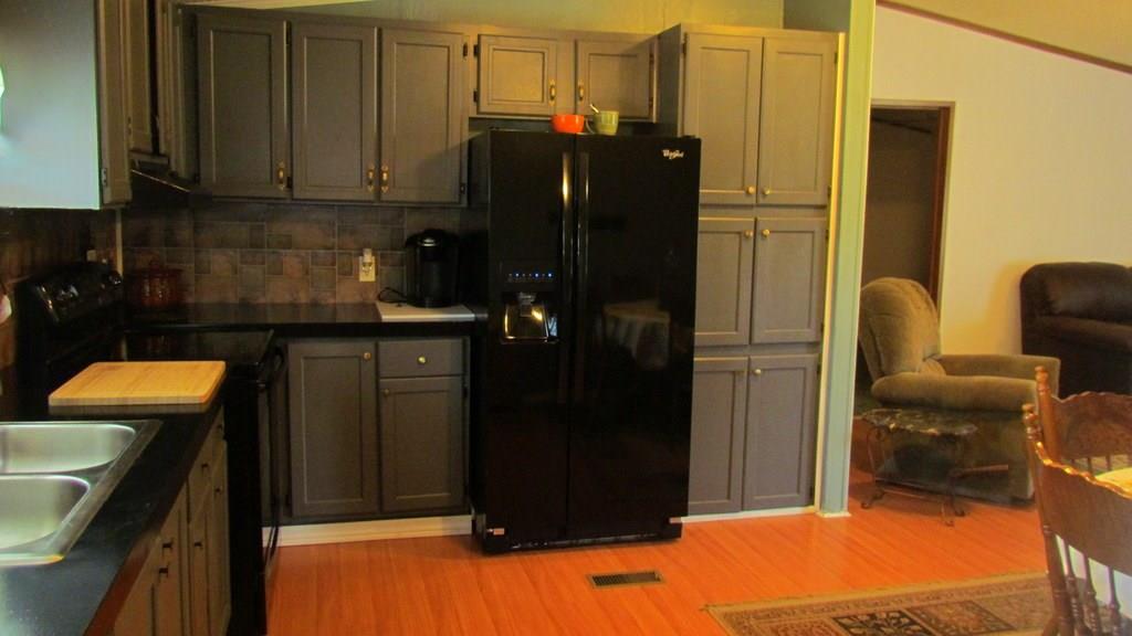 1317 Poole Gooden Road Hiddenite, NC 28636 - Photo 15 of 36 a kitchen with a refrigerator and cabinets