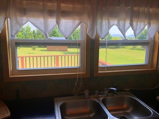 1317 Poole Gooden Road Hiddenite, NC 28636 - Photo 16 of 36 a bathroom with a sink a window and a vanity