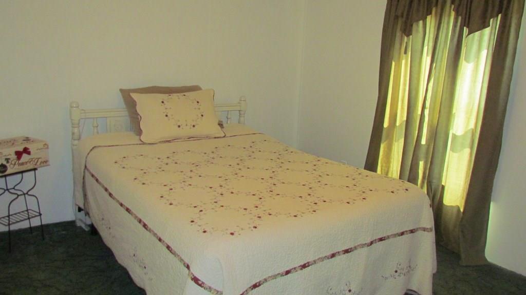 1317 Poole Gooden Road Hiddenite, NC 28636 - Photo 21 of 36 a bed sitting in a bedroom next to a window