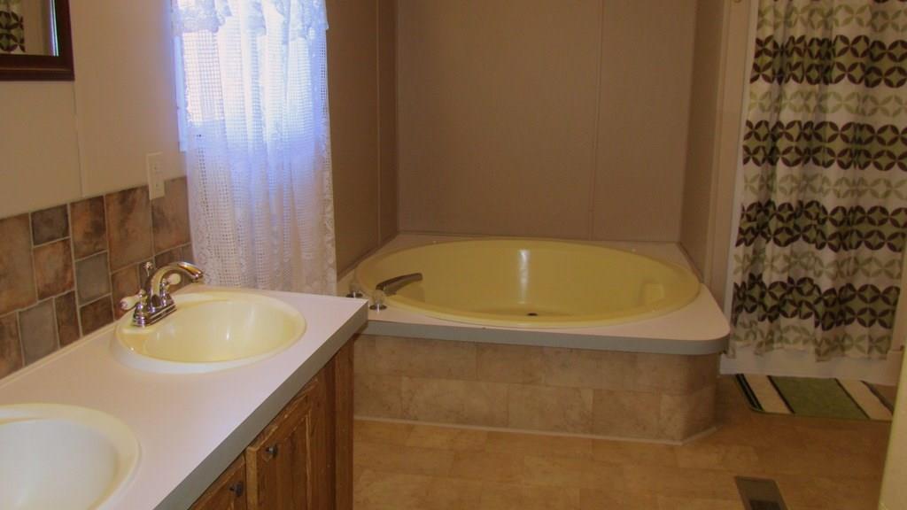 1317 Poole Gooden Road Hiddenite, NC 28636 - Photo 25 of 36 a bathroom with a sink and a bathtub