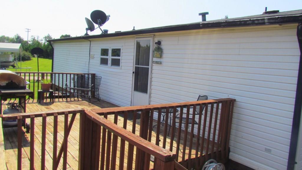 1317 Poole Gooden Road Hiddenite, NC 28636 - Photo 29 of 36 a view of a house with wooden deck and furniture