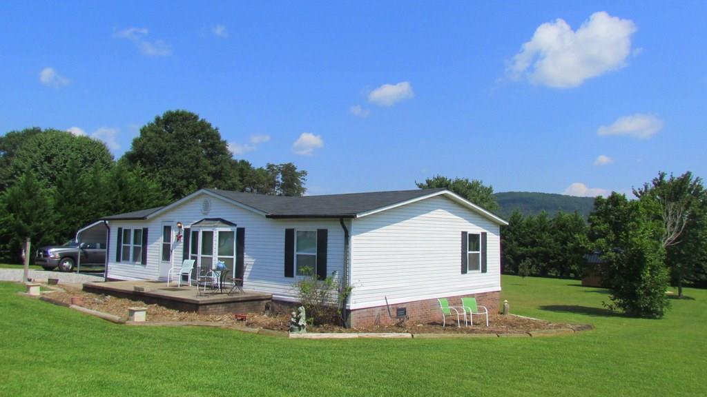 1317 Poole Gooden Road Hiddenite, NC 28636 - Photo 32 of 36 a front view of house with yard and green space
