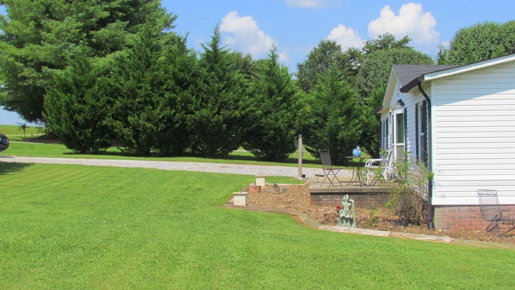 1317 Poole Gooden Road Hiddenite, NC 28636 - Photo 34 of 36 a view of a house with a backyard